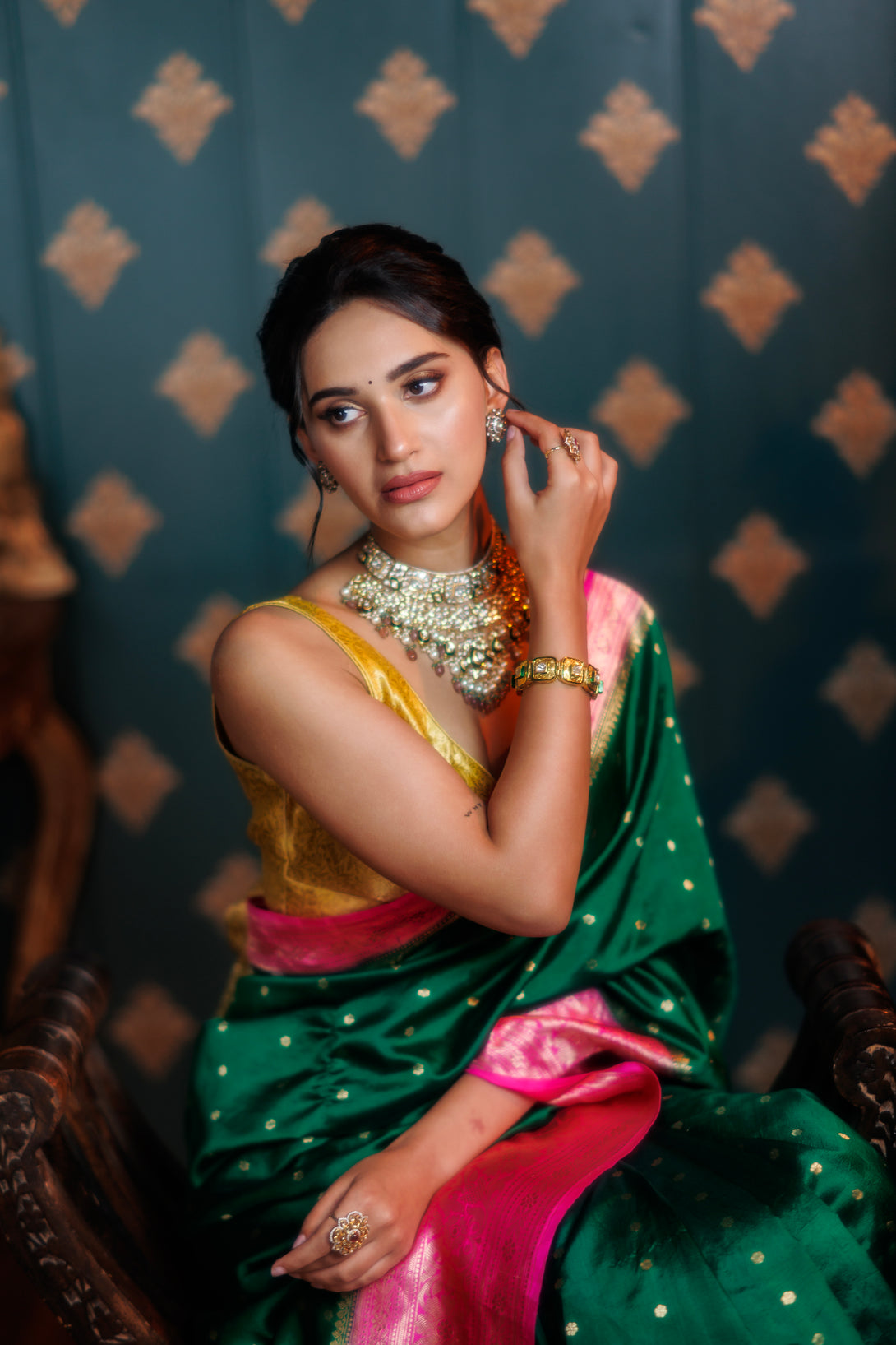 Elegant Green Handwoven Silk Saree with Vibrant Pink Contrast Border paired with complementary accessories. The saree's fusion of green and pink creates a harmonious and eye-catching ensemble, perfectly complemented by the accessories for a complete and stylish look.