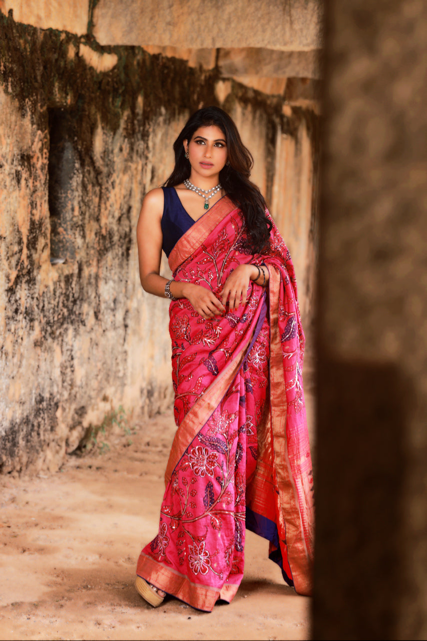 Beautiful drape of the Hot Pink Paithani Silk Saree with Kalamkari and Sequin Embroidery. The lustrous silk fabric drapes gracefully, accentuating the exquisite embroidery work and vibrant colors, creating a stunning visual effect.