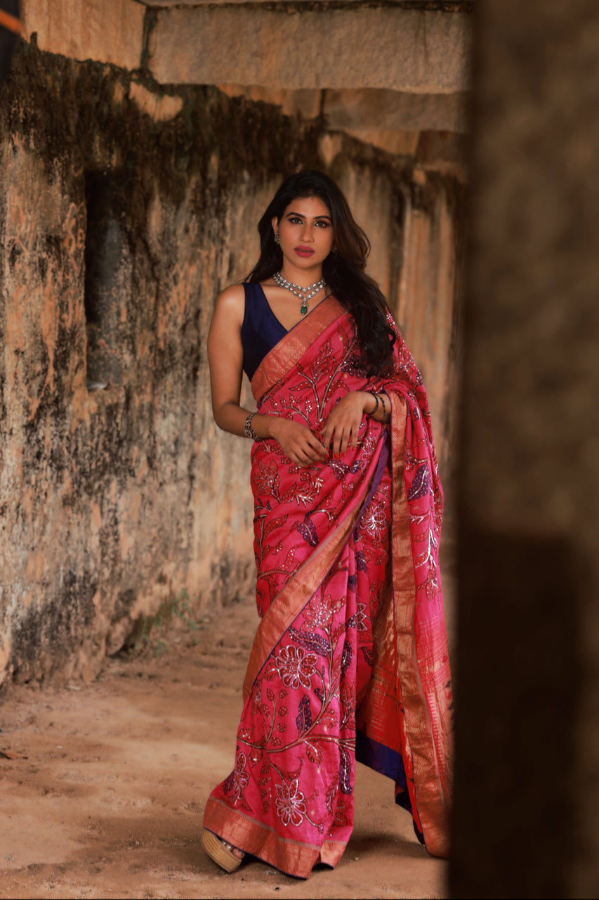 Beautiful drape of the Hot Pink Paithani Silk Saree with Kalamkari and Sequin Embroidery. The lustrous silk fabric drapes gracefully, accentuating the exquisite embroidery work and vibrant colors, creating a stunning visual effect.