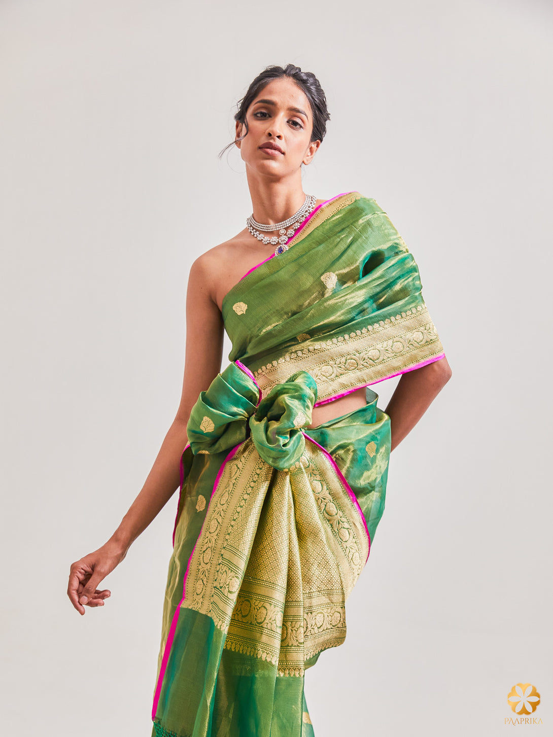 Exquisite Bottle Green and Gold Handwoven Tissue Saree with Contrast Popping Pink Selvedge - Sophistication and Charm Combined.