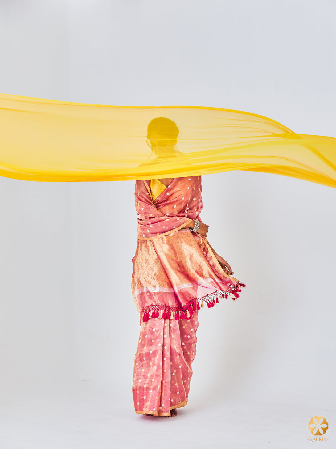 A Stylish Woman Wearing Elegant Blush Pink Handwoven Tissue Saree - Effortless Sophistication.