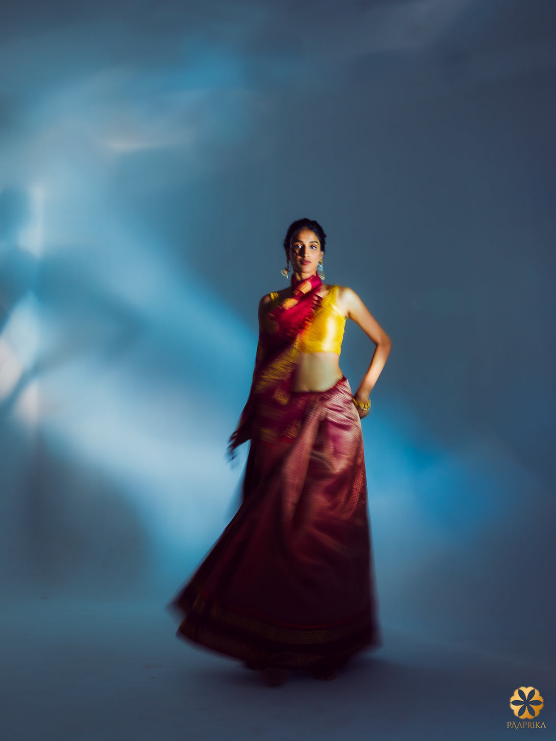 Stylish Woman in Regal Maroon Kanjivaram Saree - Graceful Elegance with Paaimadi and Gandaberunda.