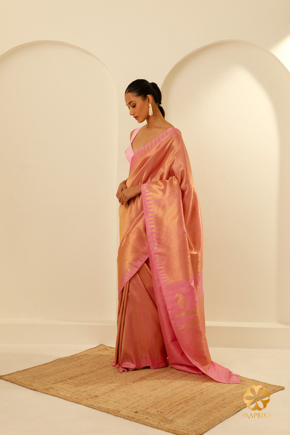 The saree elegantly draped on a mannequin, showcasing its cultural richness and craftsmanship.