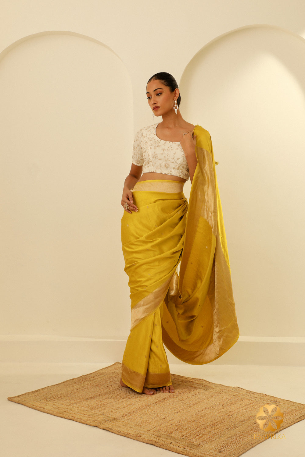 A full view of the saree, draped elegantly, to capture its overall design and dynamic scattered butis.
