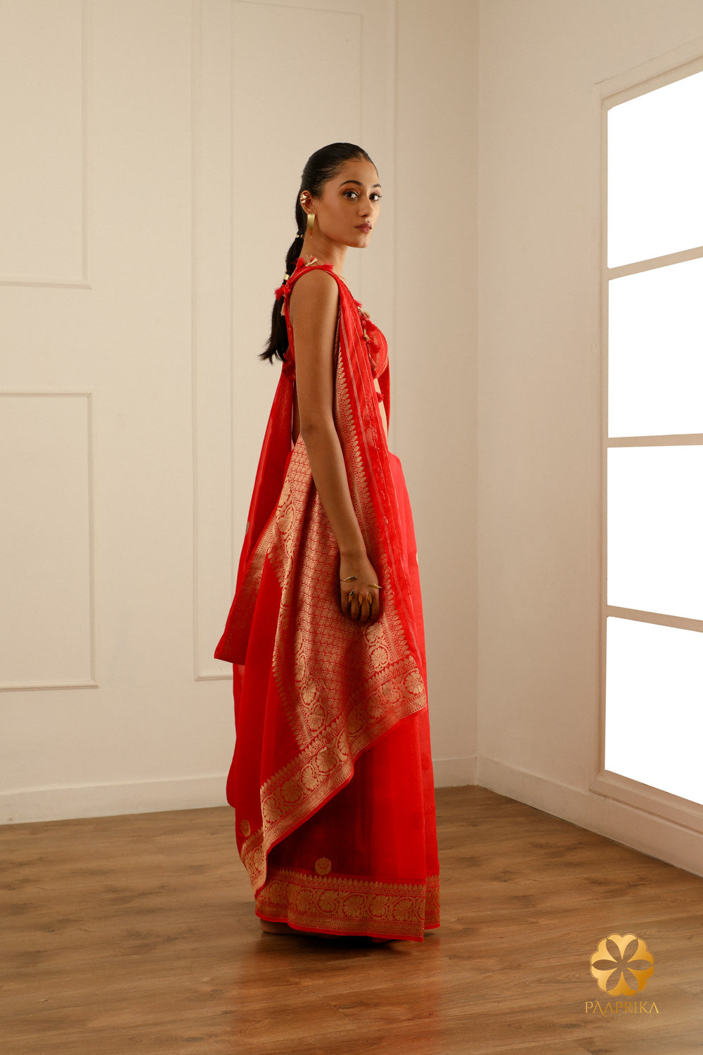A detailed look at the handwoven floral motifs adorning the saree's delicate fabric.