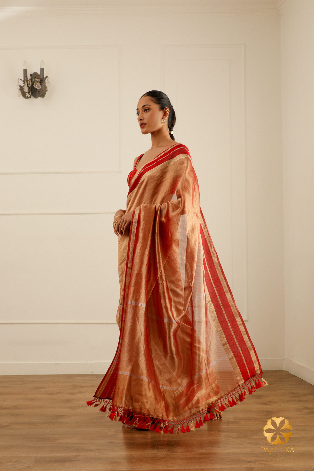 A close-up of the saree's pallu, highlighting the woven zari details and the refined craftsmanship.