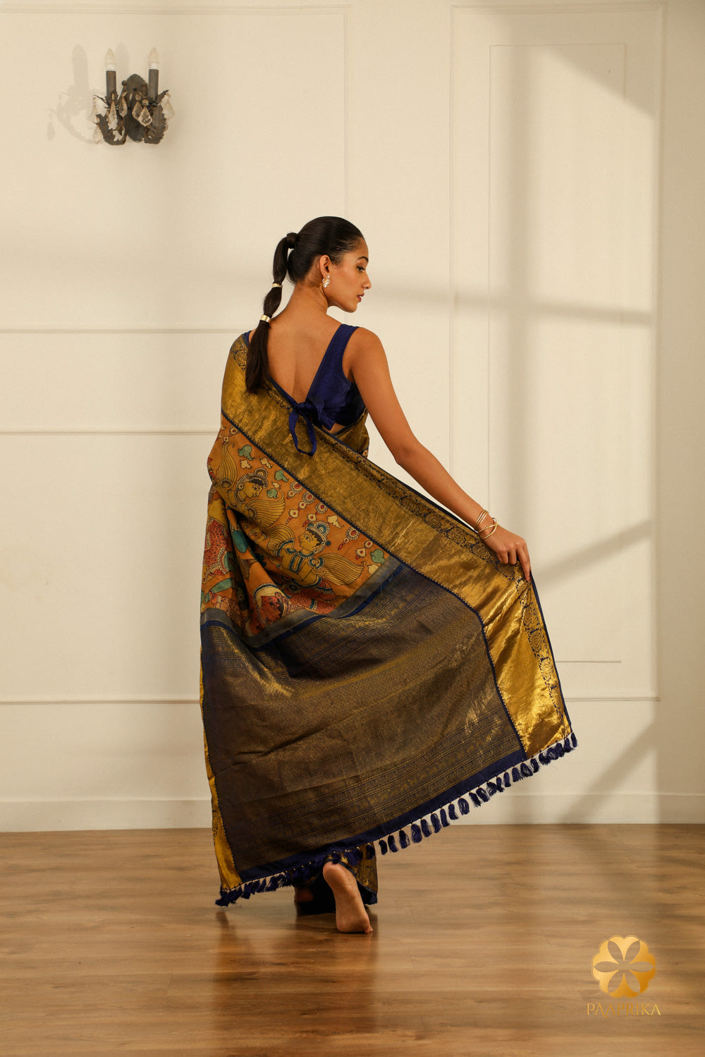 A full-length shot of a woman gracefully draped in the Kanjivaram saree, radiating cultural richness and spiritual significance.