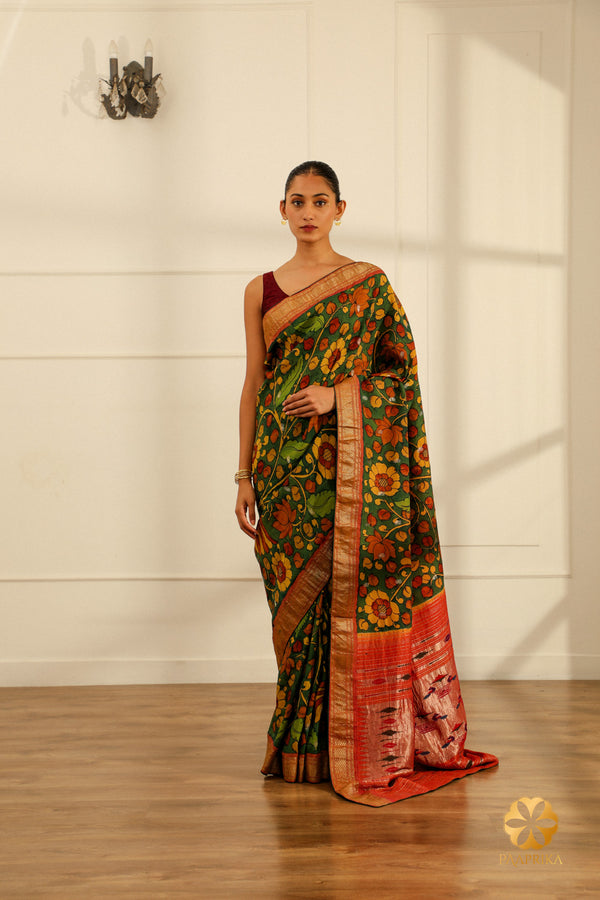 The saree elegantly displayed on a mannequin, capturing the beauty of the Kalamkari design, the contrasting border, and the peacock detailing.