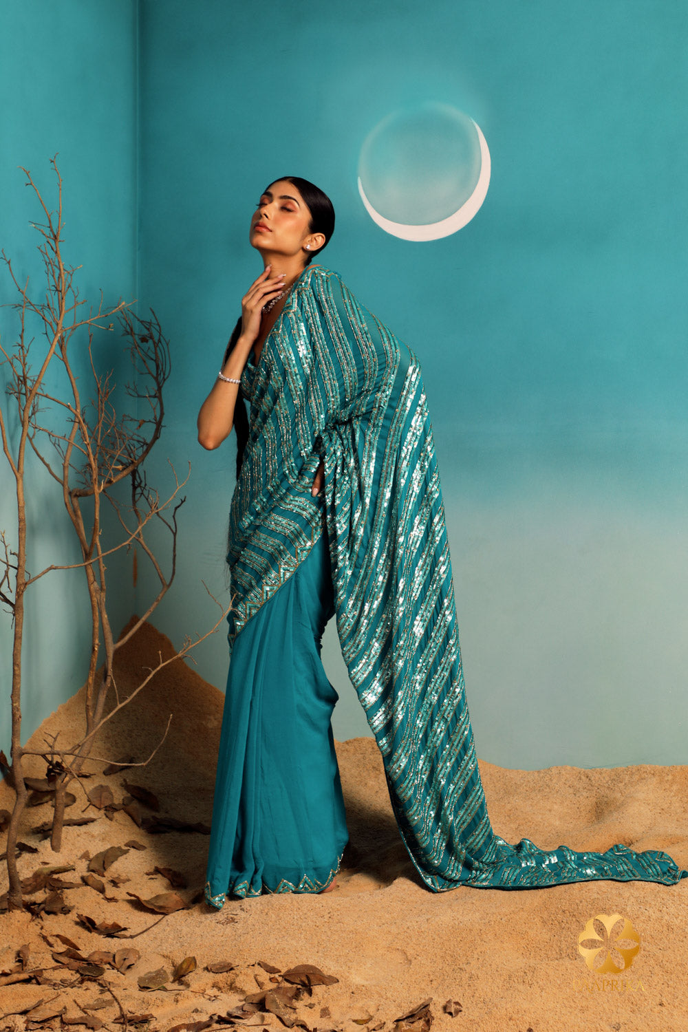 Exquisite teal pure georgette saree with intricate triangular pattern embroidery using sequins and cut dana.