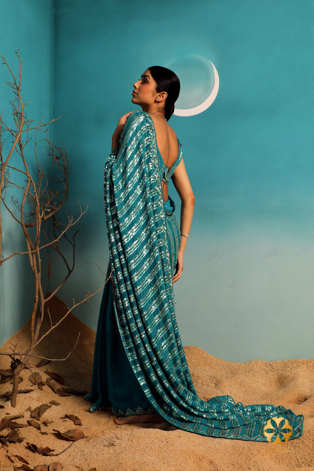 Elegant teal pure georgette saree featuring intricate triangular pattern embroidery using sequins and cut dana.