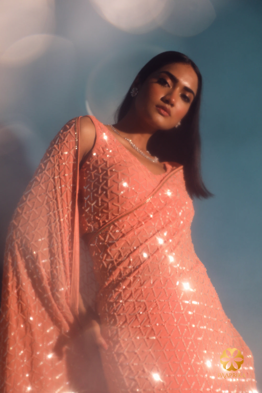 Hand-embroidered peach-colored sequins saree designed with an intricate geometric pattern. Stand out at cocktail events. Personalize the color to your preference. Learn more on our website.