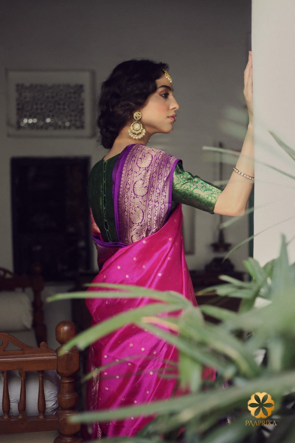 A stylish woman confidently wearing the Regal Purple Handwoven Spun Silk Saree with Intricate Gold Border. The saree's regal purple color and intricate gold border enhance her overall look, exuding an air of elegance and grandeur.