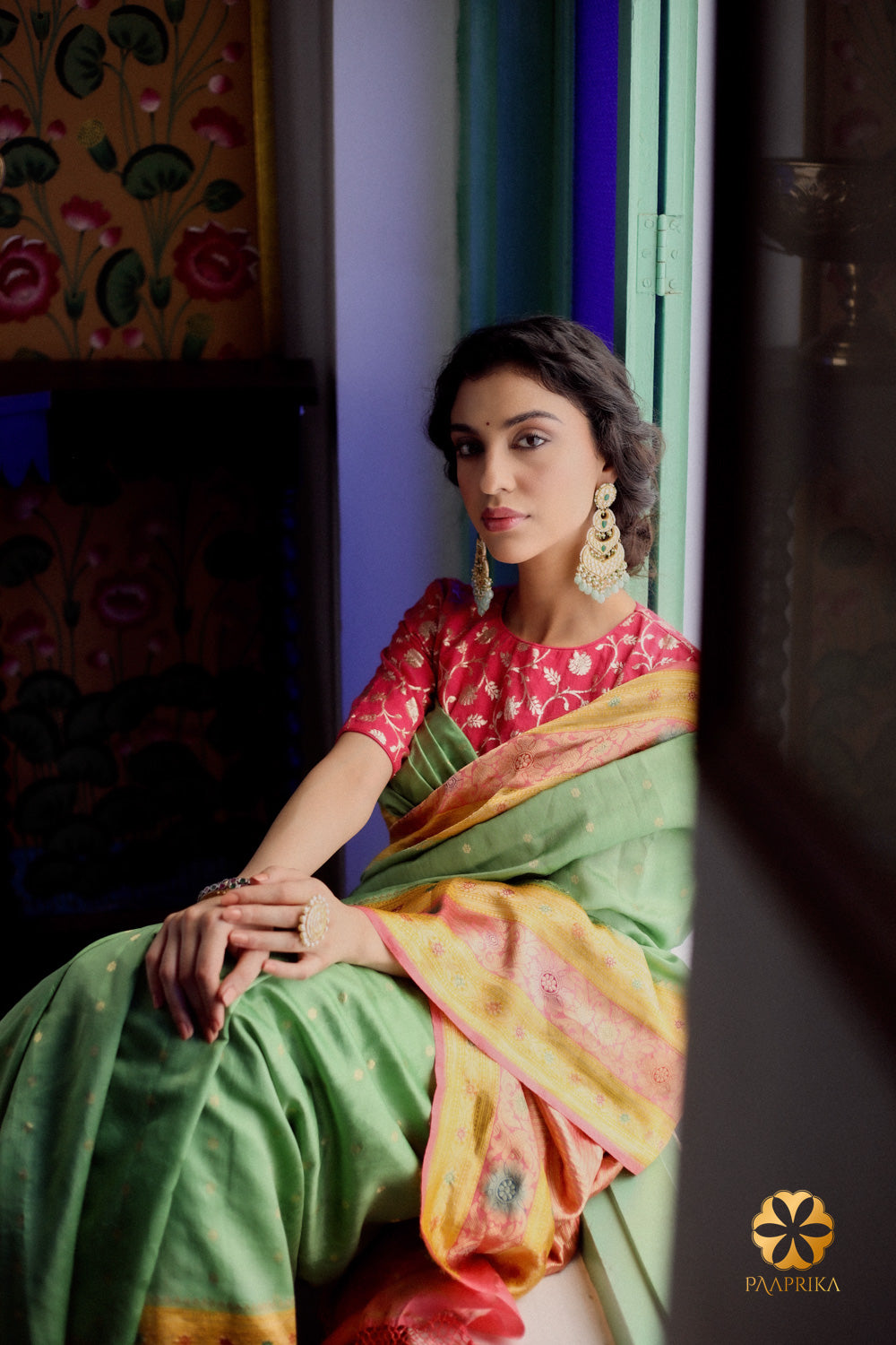 Enchanting mint green handwoven spunsilk saree adorned with striking multicolor motifs, a testament to craftsmanship.