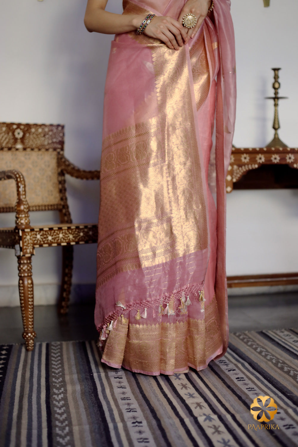 Beautiful drape of the Pastel Onion Pink Banarasi Organza Saree, exuding delicate elegance. The lightweight organza fabric drapes gracefully, creating a soft and ethereal look.