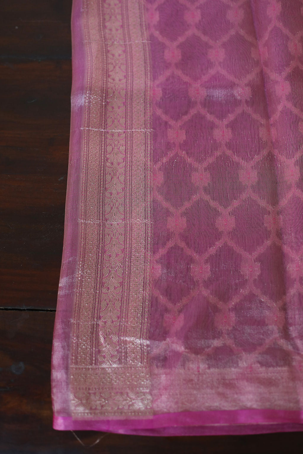 Pink saree with delicate tissue detailing in a mesmerizing Moroccan pattern, a perfect blend of grace and intricate craftsmanship.