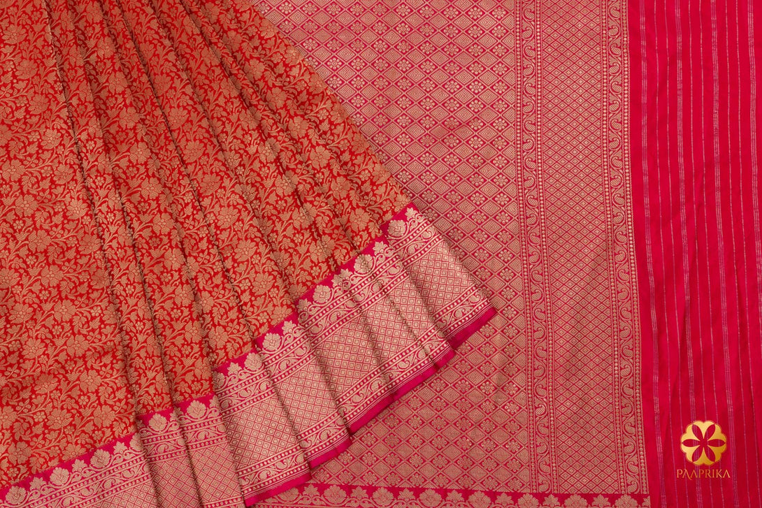 A side view of the saree, emphasizing its hot pink border.