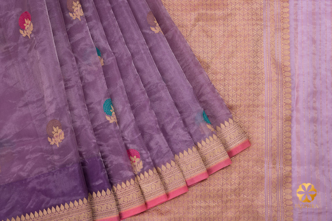 The striking contrast of the rose pink selvedge on the lavender saree.