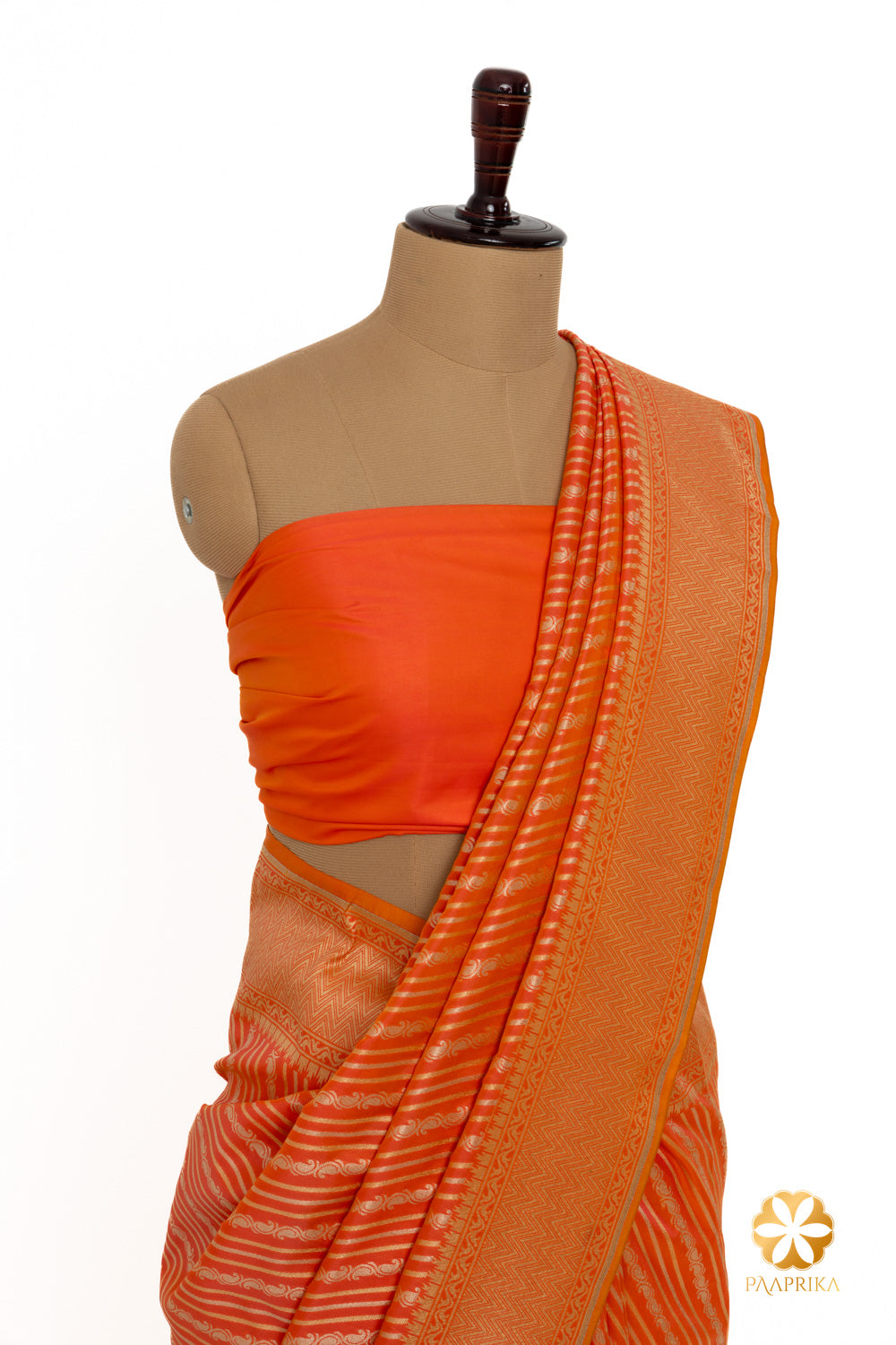 Vibrant orange Banarasi saree exuding energy and style.