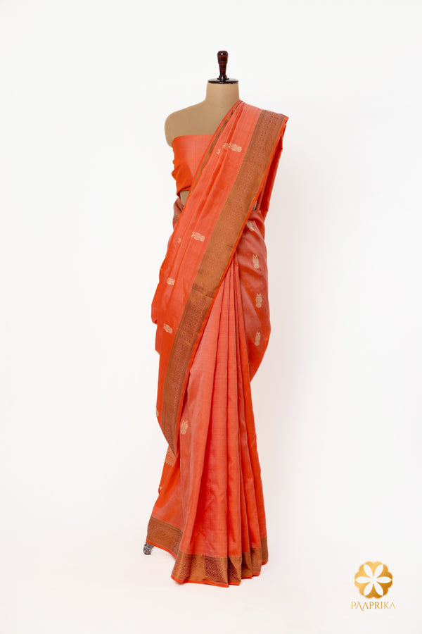 Handwoven pure silk saree in coral color with beige and silver-white thread embellishments.