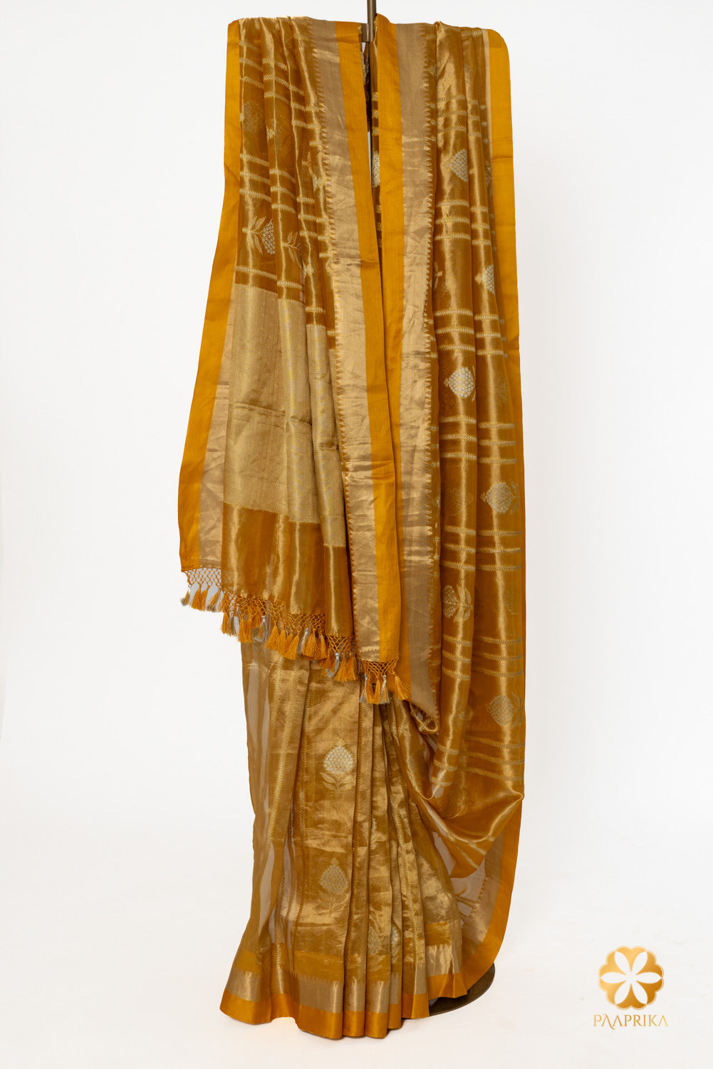 Close-up of the intricate temple border on the golden mustard saree.