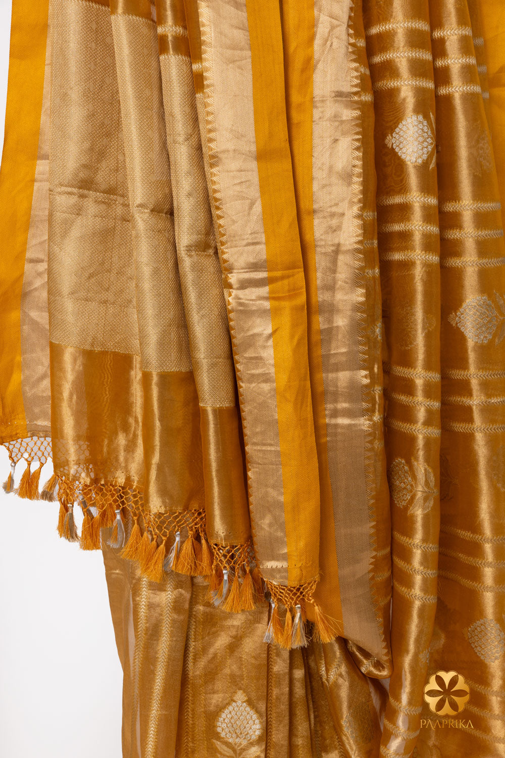 Golden mustard saree draping gracefully, combining traditional elegance and modern allure.