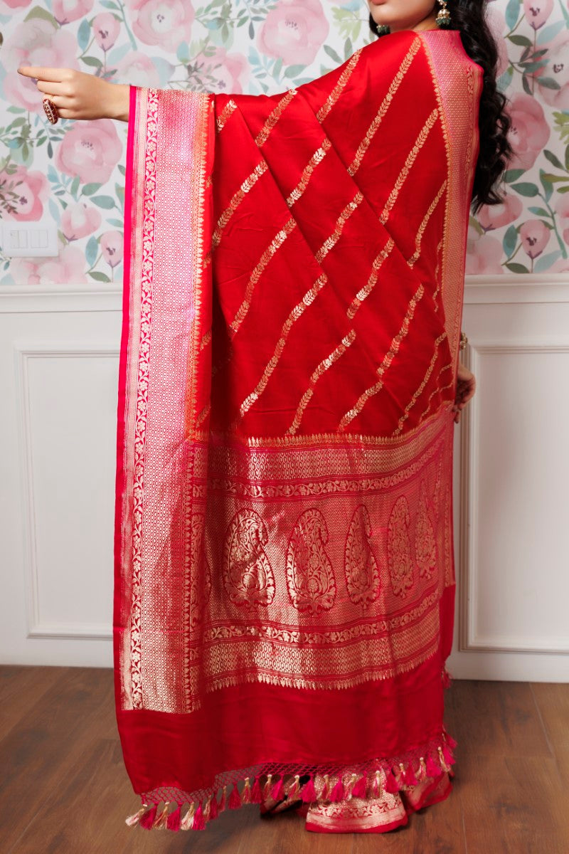 Woman draped in the Red Saree with Pink Border - A Captivating Traditional Look