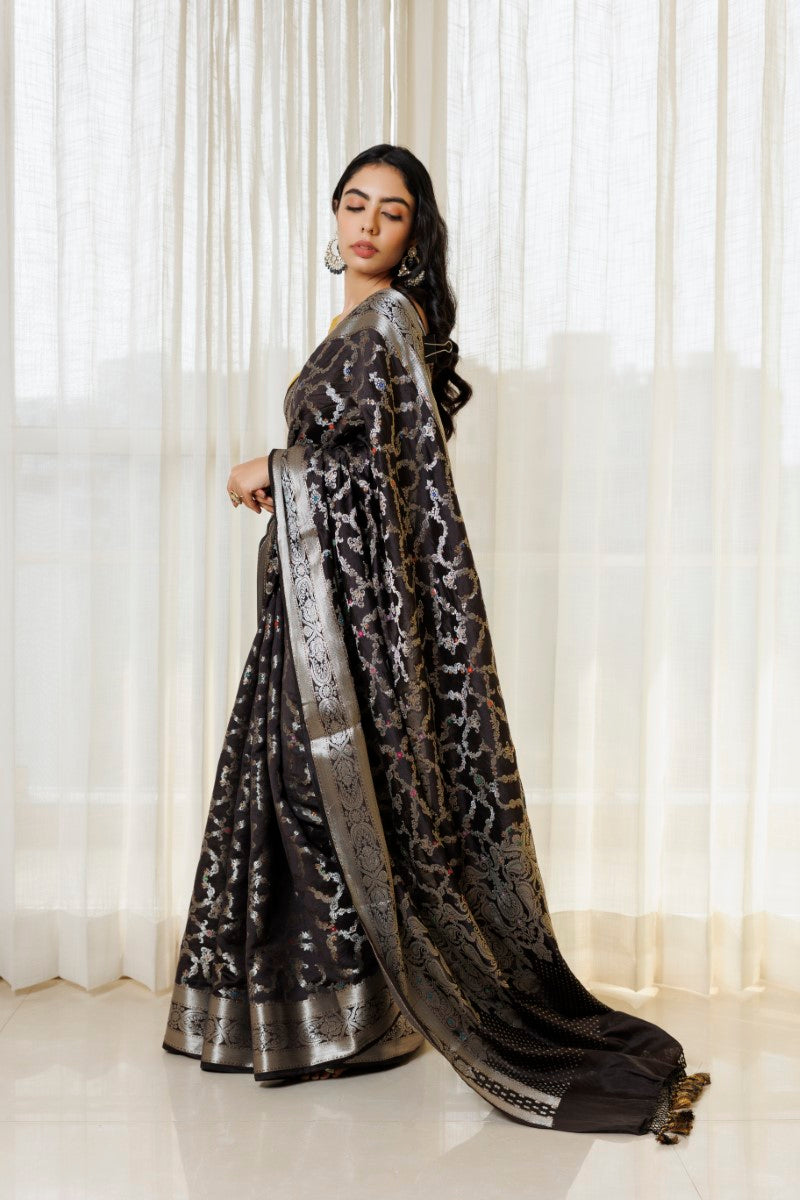 Beautiful drape of the Elegant Black & Silver Pure Spunsilk Saree. The soft and luxurious fabric gracefully wraps around the body, emphasizing the saree's elegance and timeless beauty.