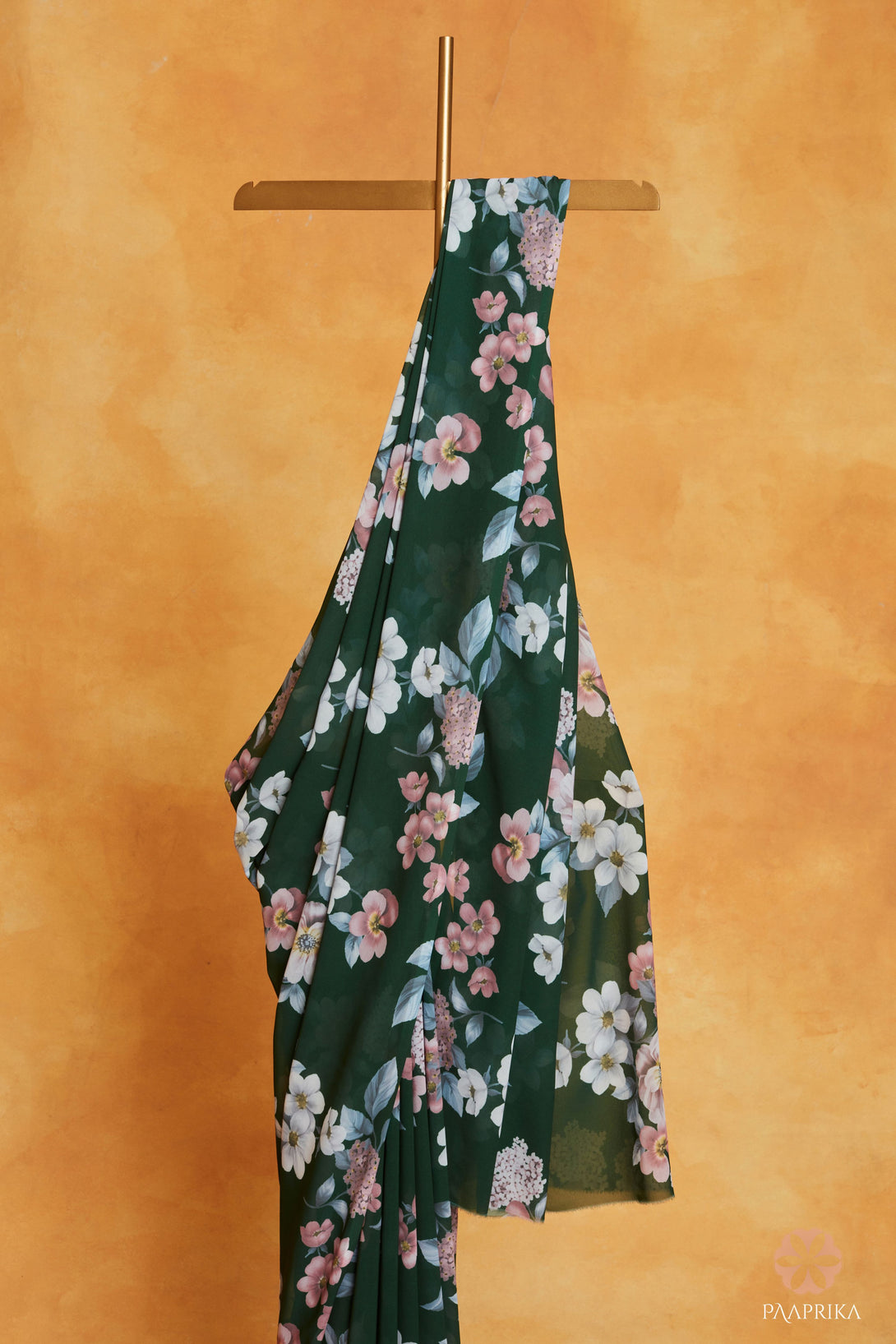 Beautiful drape of the Trendy Bottle Green Floral Printed Georgette Saree, staying fashion-forward with the essence of nature's bloom. The lightweight georgette fabric drapes effortlessly, showcasing the captivating floral prints.