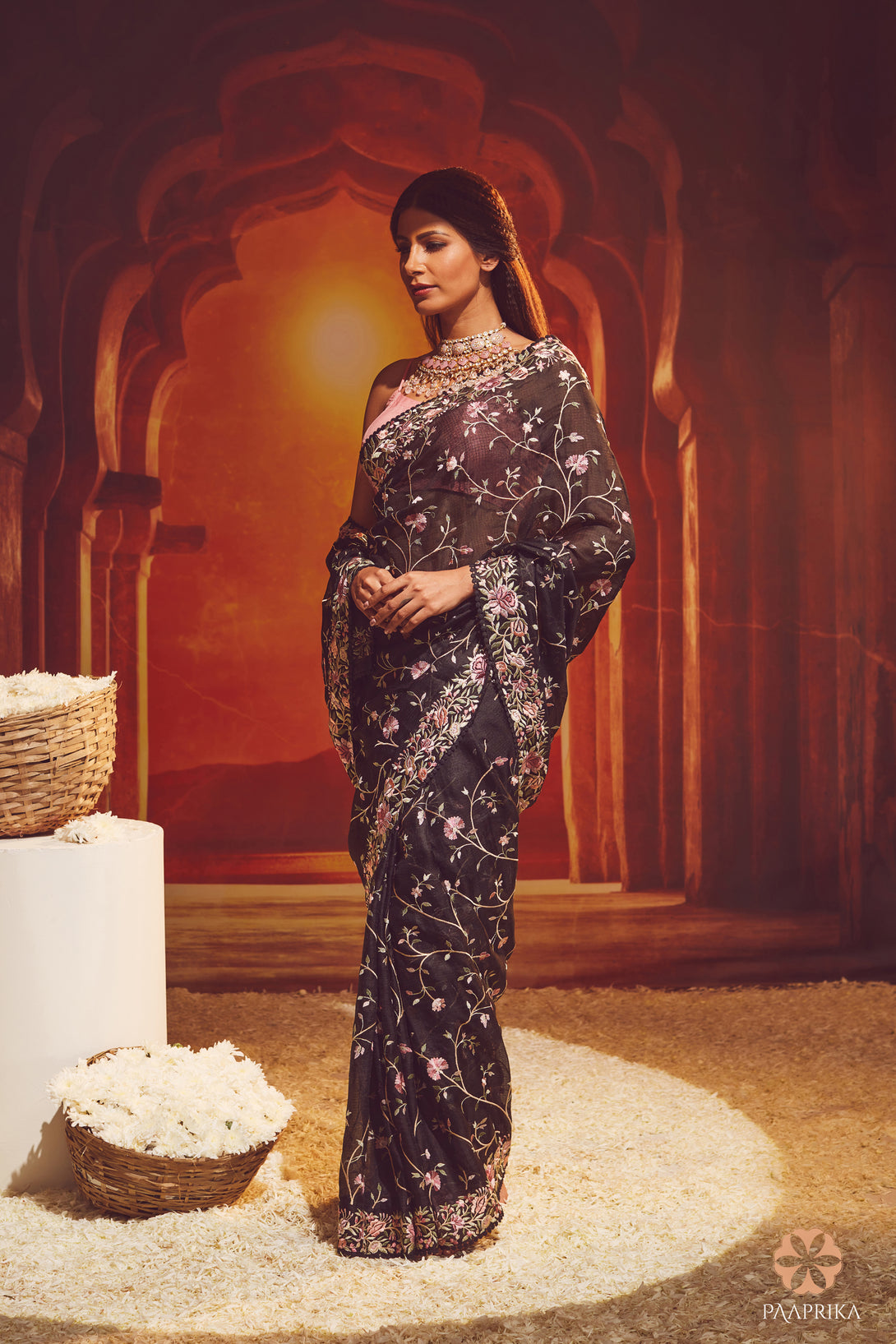 Beautiful drape of the Captivating Black Kota Silk Floral Embroidered Saree, elevating your fashion game with grace. The lightweight and flowy Kota silk fabric drapes effortlessly, showcasing the embroidered floral motifs.