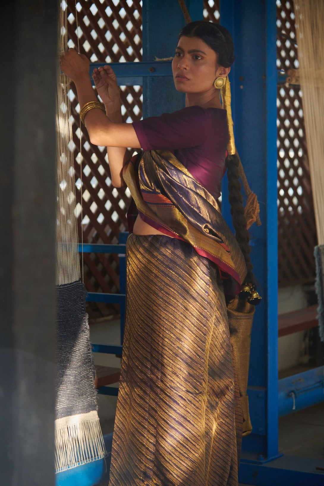 A stylish woman wearing the Exquisite Blue Brocade Rangkat Tissue Handwoven Kanjivaram Saree, exuding grace and sophistication. The saree's intricate brocade pattern adds an extra layer of charm to her appearance.