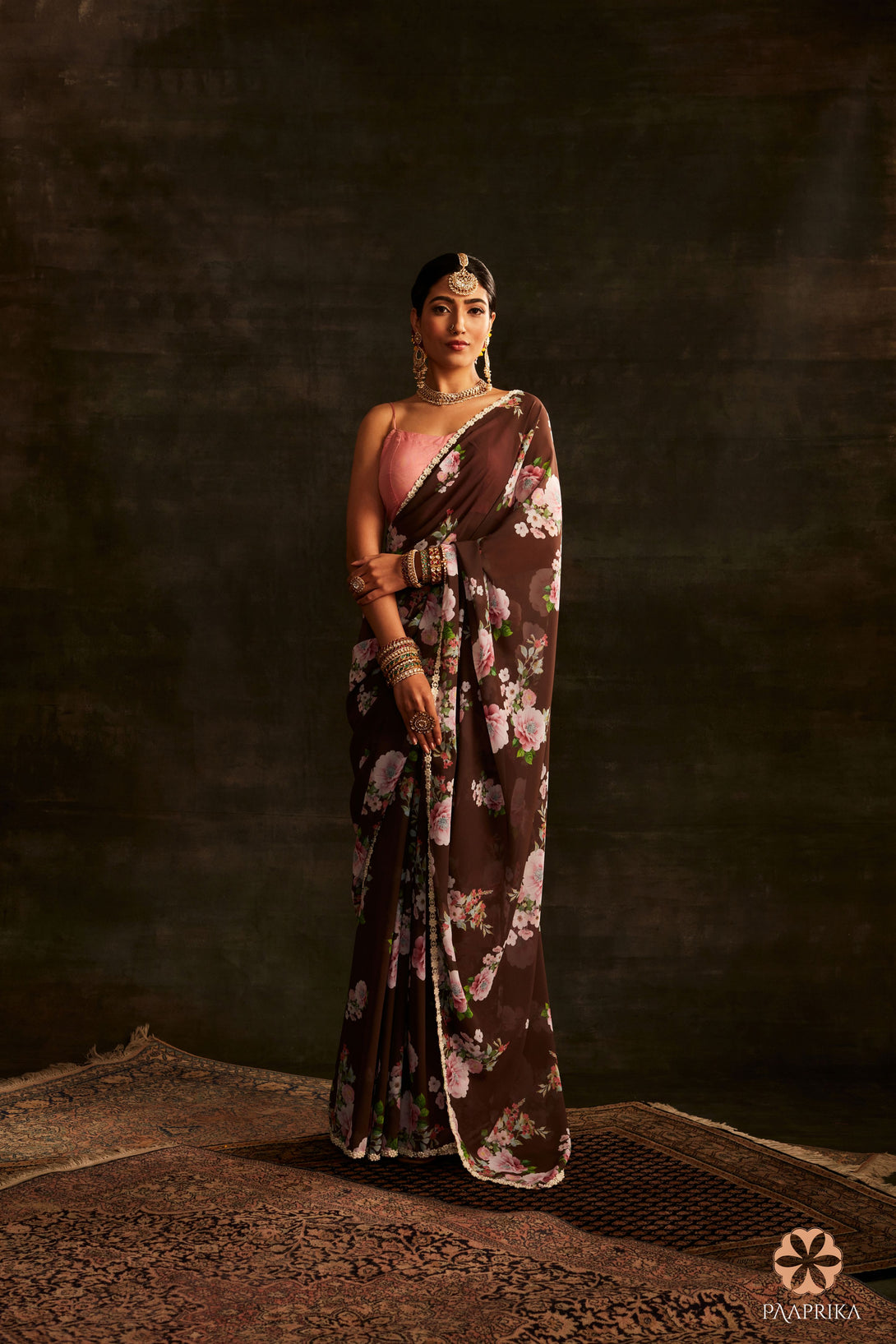  Beautiful drape of the Trendy Brown Floral Printed Georgette Saree, exuding earthy elegance. The lightweight georgette fabric drapes gracefully, highlighting the captivating floral prints.