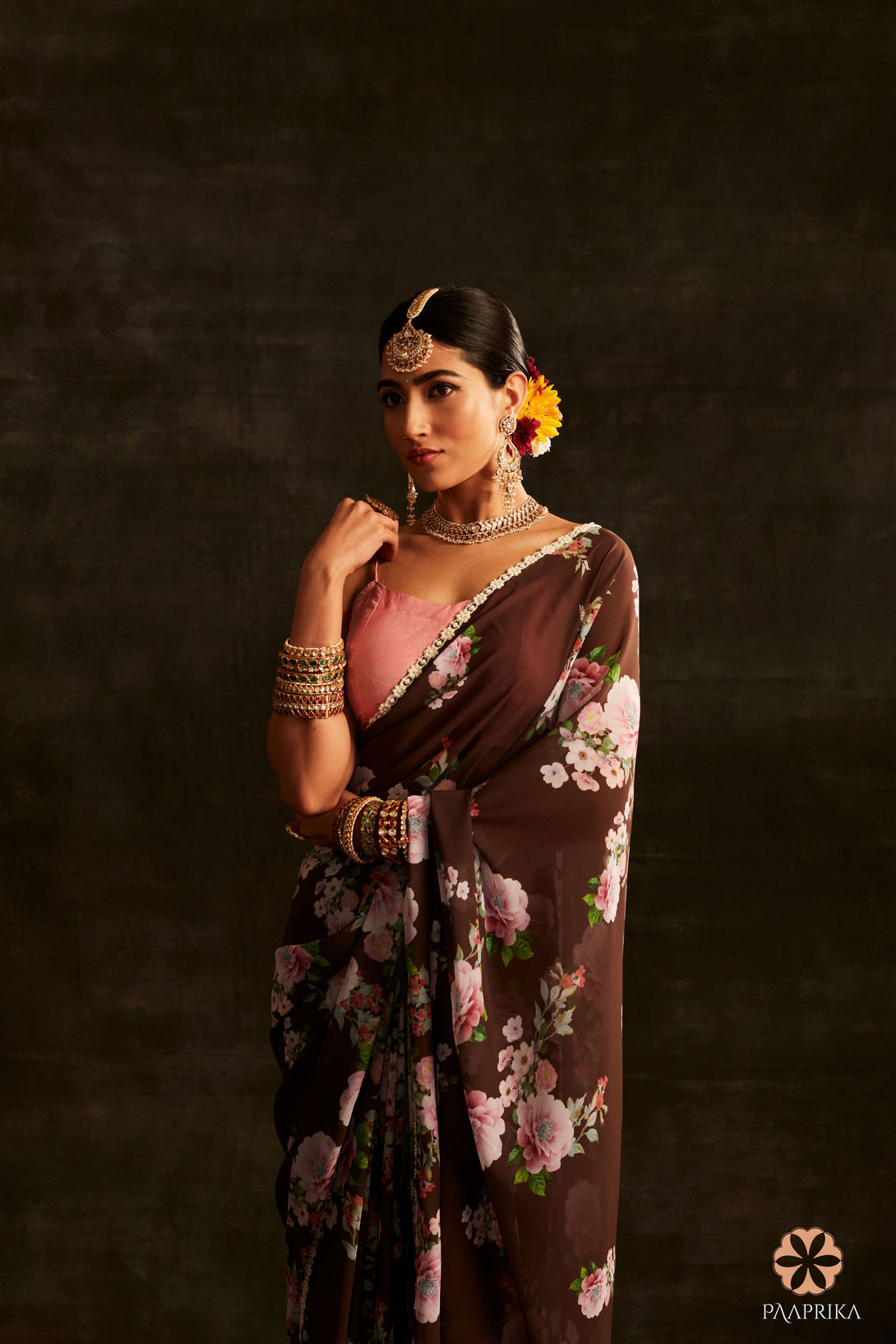 Close-up of the intricate floral print on the Trendy Brown Georgette Saree. The rich brown color and detailed floral pattern add a touch of sophistication and natural beauty to the georgette fabric.