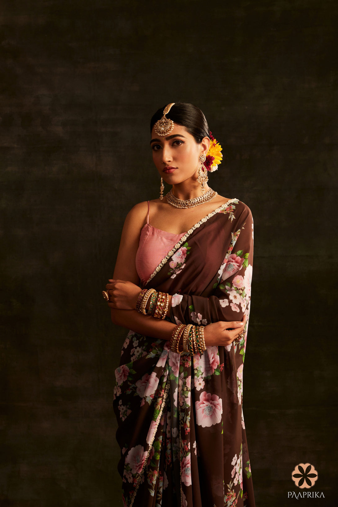  Beautiful drape of the Trendy Brown Floral Printed Georgette Saree, exuding earthy elegance. The lightweight georgette fabric drapes gracefully, highlighting the captivating floral prints.