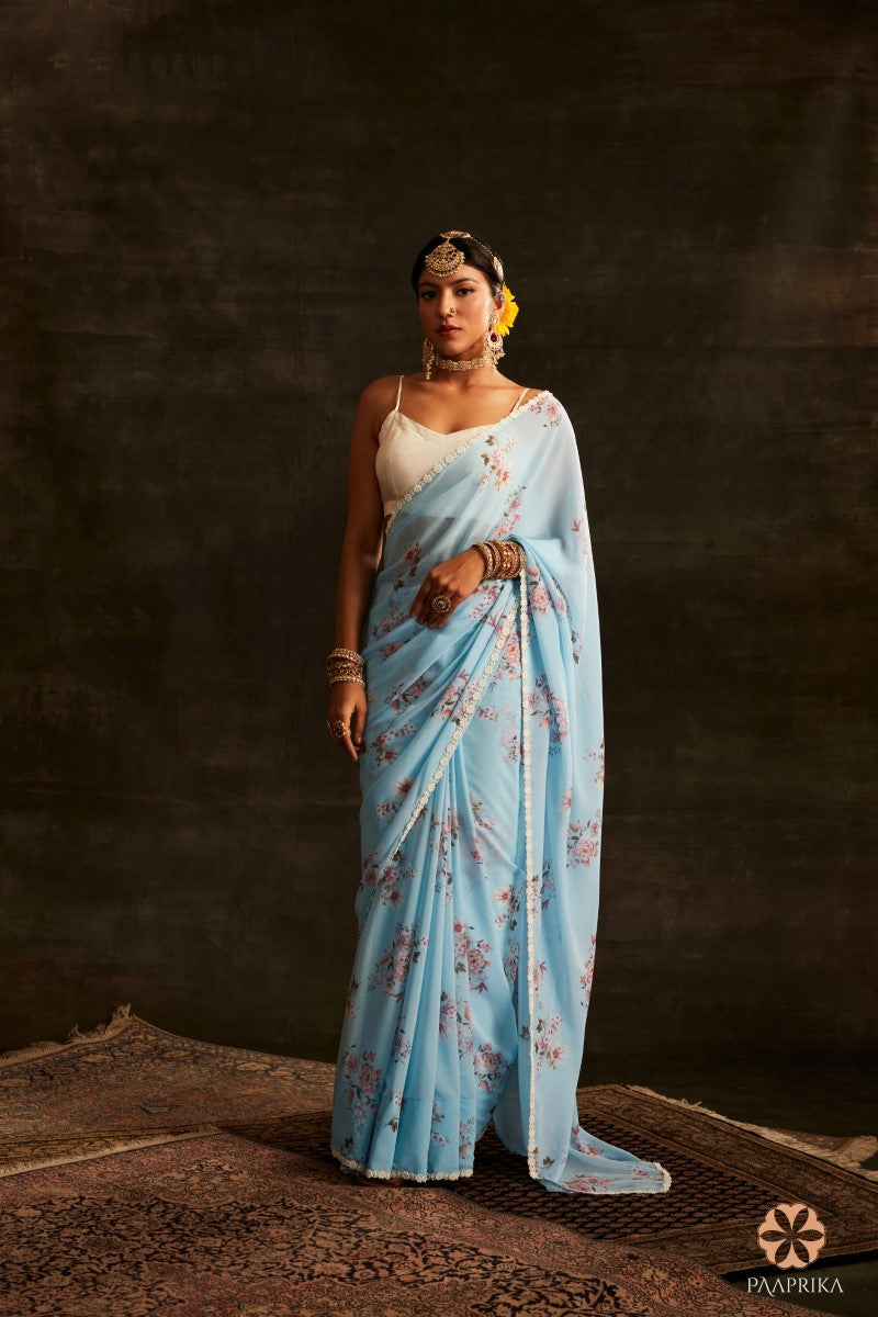 Gorgeous Aqua Blue Floral Printed Georgette Saree featuring serene blooms, a perfect choice to make a fashion statement.