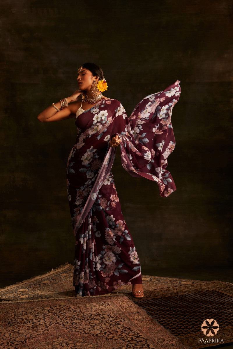 Beautiful drape of the Chic Dark Magenta Floral Printed Georgette Saree, showcasing its effortless style and floral grace. The lightweight georgette fabric drapes fluidly, accentuating the captivating floral prints.
