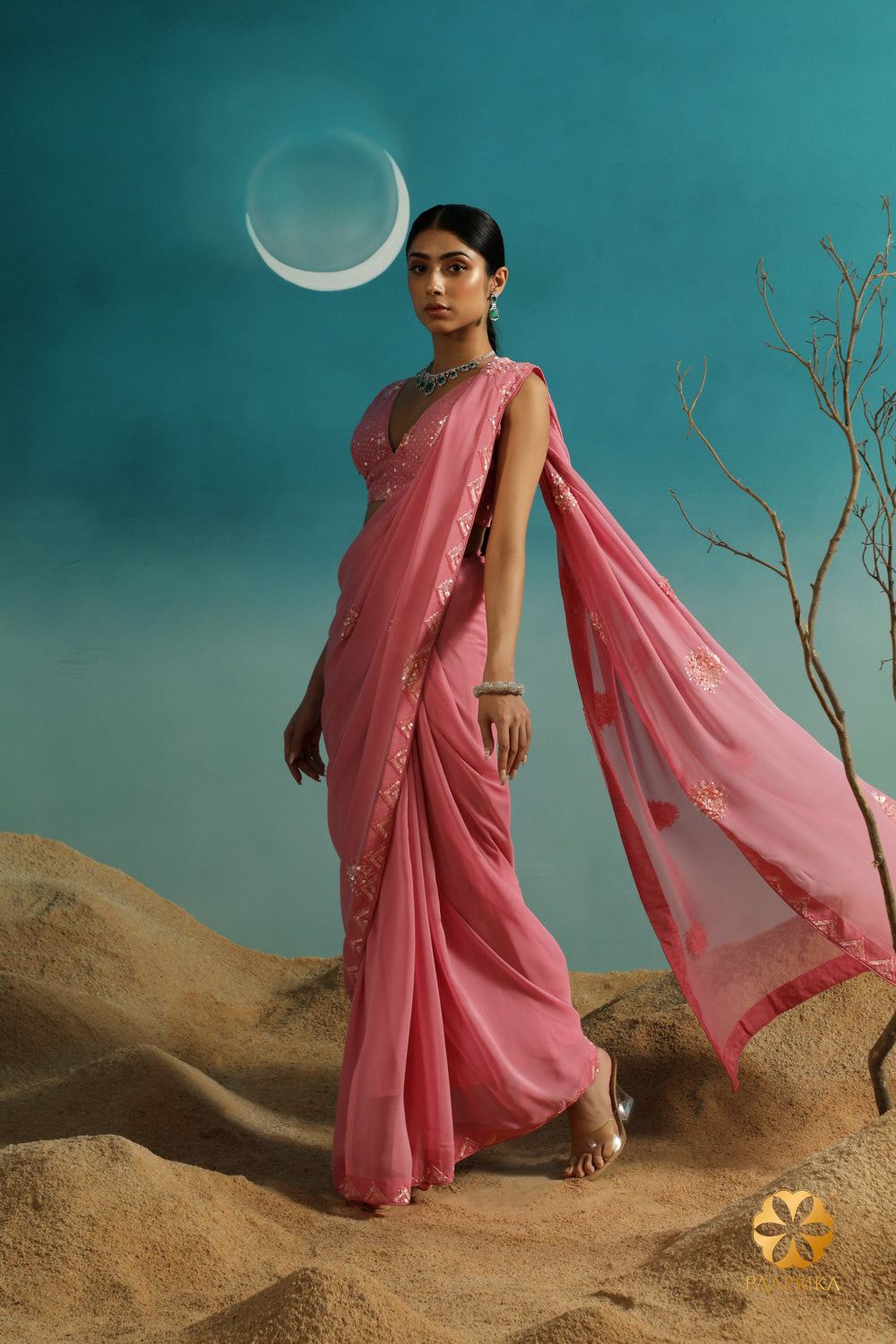 A delicate pastel rose georgette saree paired with a hand-embroidered blouse. Perfect for elegant occasions.