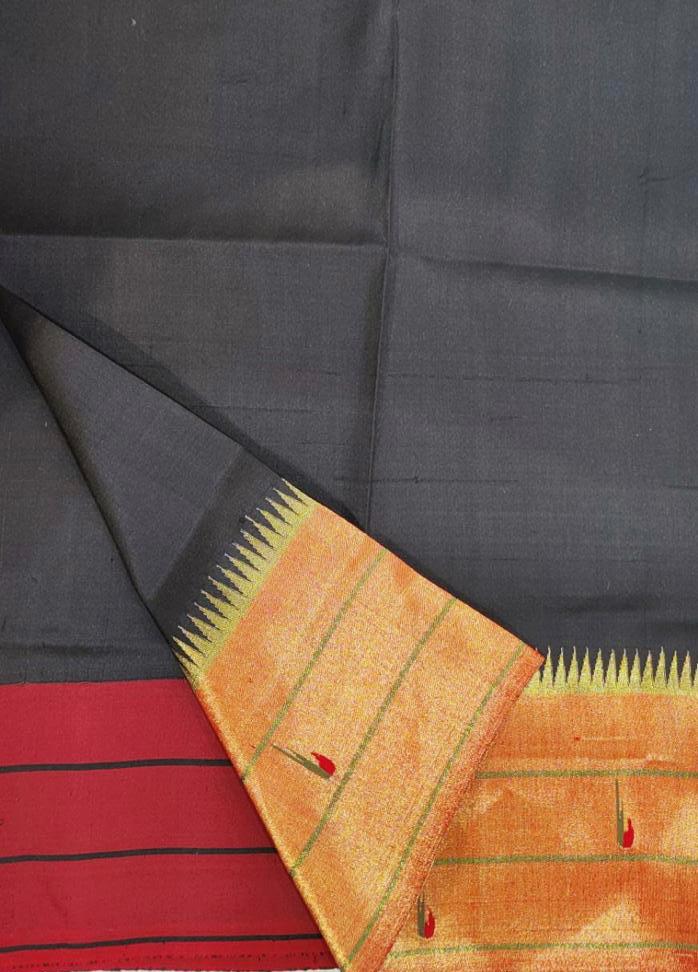 Close-up of the intricate Muniya motifs on the Stunning Black Triple Muniya Handwoven Paithani Silk Saree. The detailed handwoven designs in vibrant colors add a touch of elegance and cultural heritage to the black silk fabric, showcasing the artistic mastery of Paithani silk sarees. Blouse fabric