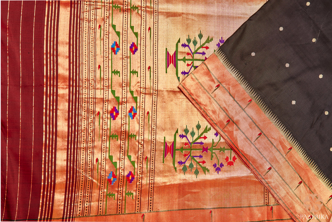 Close-up of the intricate Muniya motifs on the Stunning Black Triple Muniya Handwoven Paithani Silk Saree. The detailed handwoven designs in vibrant colors add a touch of elegance and cultural heritage to the black silk fabric, showcasing the artistic mastery of Paithani silk sarees.
